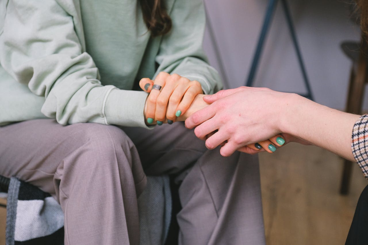 The Art of Drawing Readers In: Your attractive post title goes here Close-up of two people holding hands during a comforting therapy session.